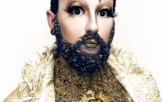 Apostrophe wearing Elektra Cosmetics Gold Creative Capsule